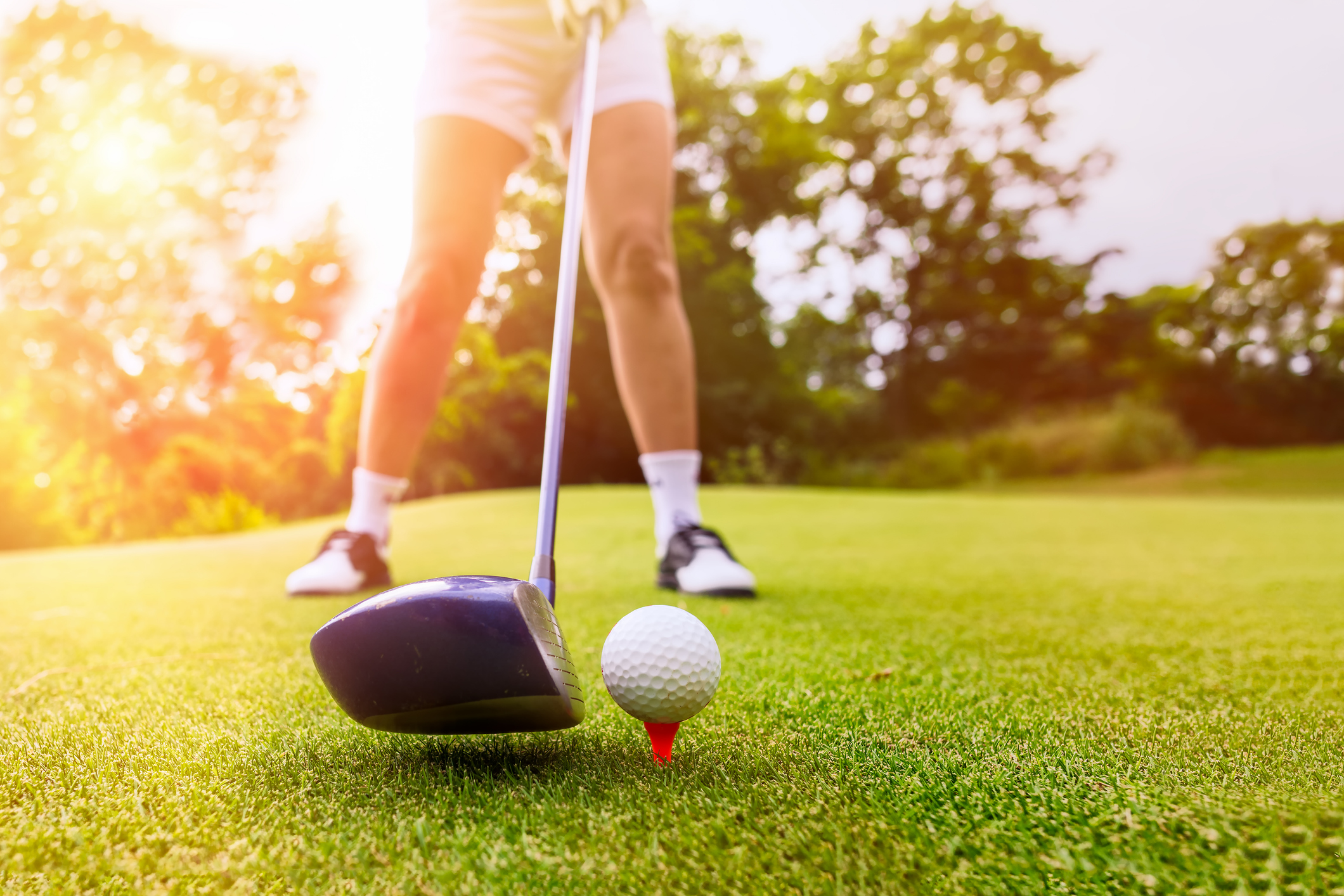 Golfer focus putting golf ball into the hole during sunset,Healthy and Lifestyle Concept.