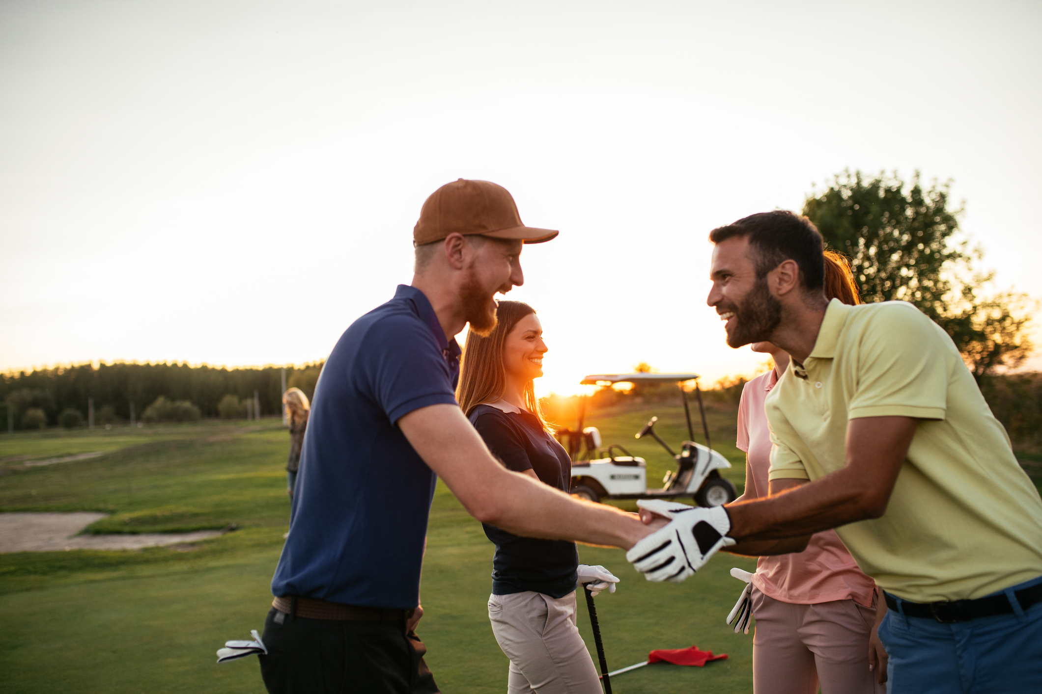 Golfing partners shaking hands after a game of golf